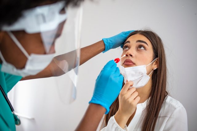 Woman taking COVID test.