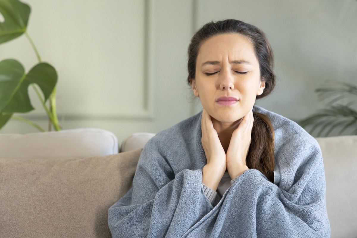 Young woman touching painful neck, sore throat for flu, cold and infection.