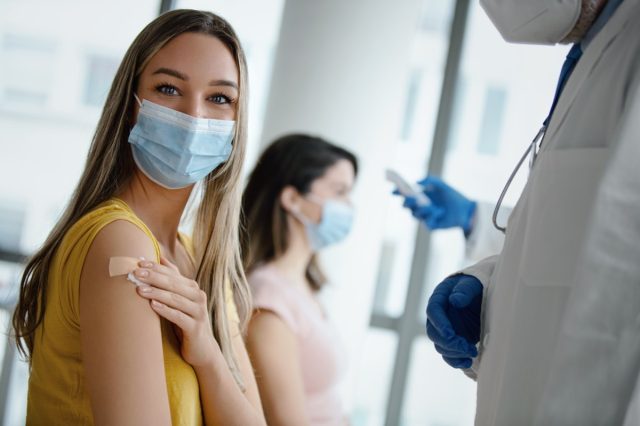 Doctor had just vaccinated a young female patient in the hospital.