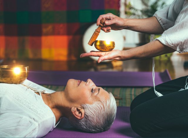 woman experiencing sound healing bath therapy