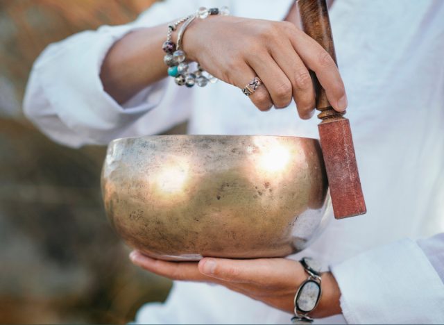 close-up woman holding bowl for sound healing