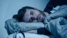 man stressed in bed that he can't sleep