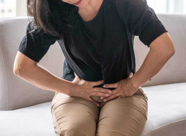woman holding pelvic area in pain