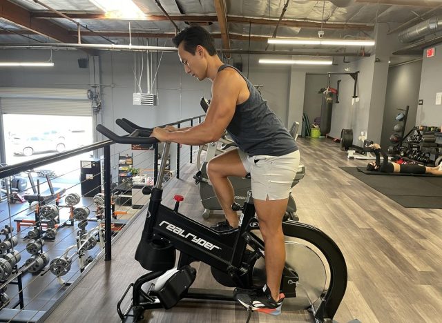 trainer cycling in gym