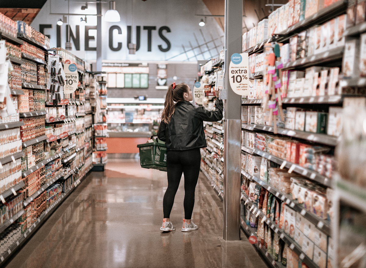 woman in athletic gear shopping in Whole Foods