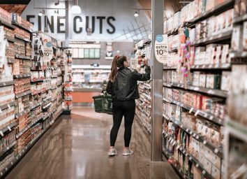 woman in athletic gear shopping in Whole Foods