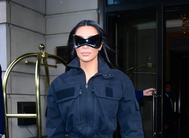 kim kardashian wears black sunglasses and jacket outside hotel
