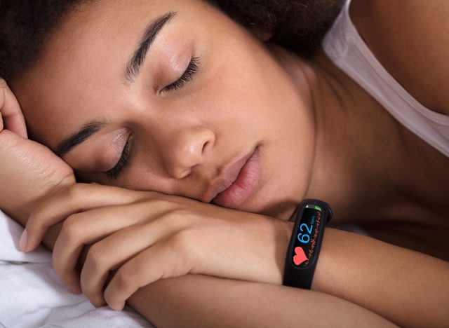 woman wearing sleep tracker as she sleeps