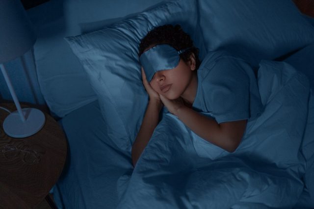 woman sleeping at night with eye mask