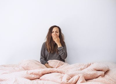 woman yawning in bed, sleepy