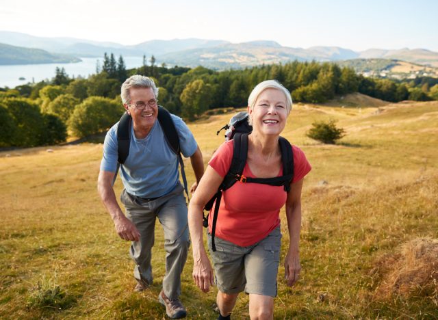 happy seniors who hate exercising out on a picturesque hike