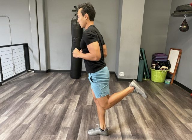 trainer doing butt kicks in gym