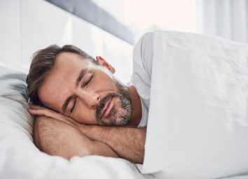man sleeping in bright room
