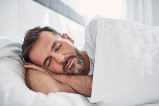 man sleeping in bright room