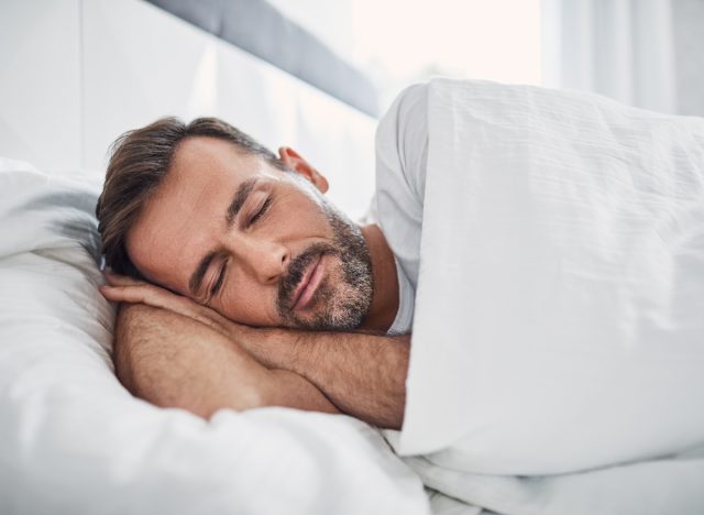 man sleeping in bright room