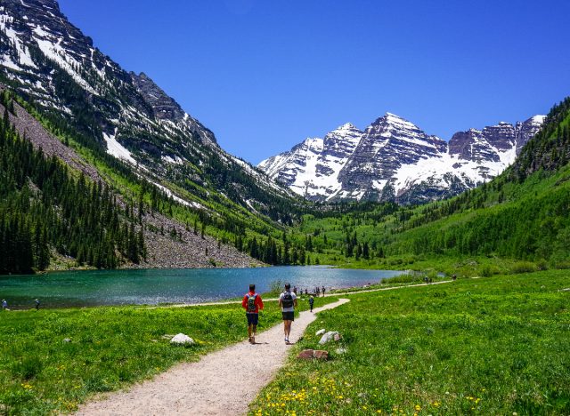 people hiking trail through aspen, colorado mountains