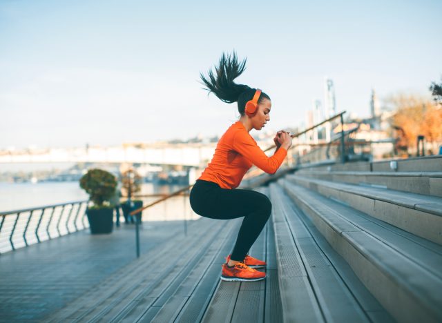 woman doing jumping squats on steps