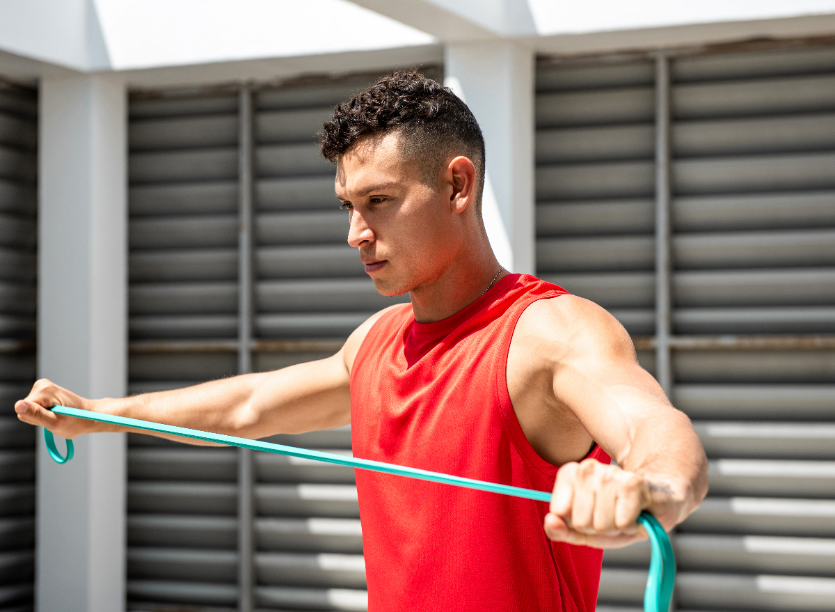 man exercising with resistance band