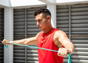 man exercising with resistance band