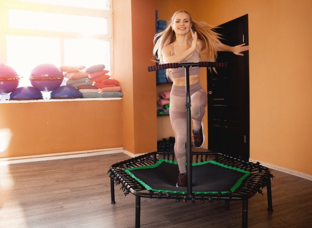 happy woman doing a trampoline workout
