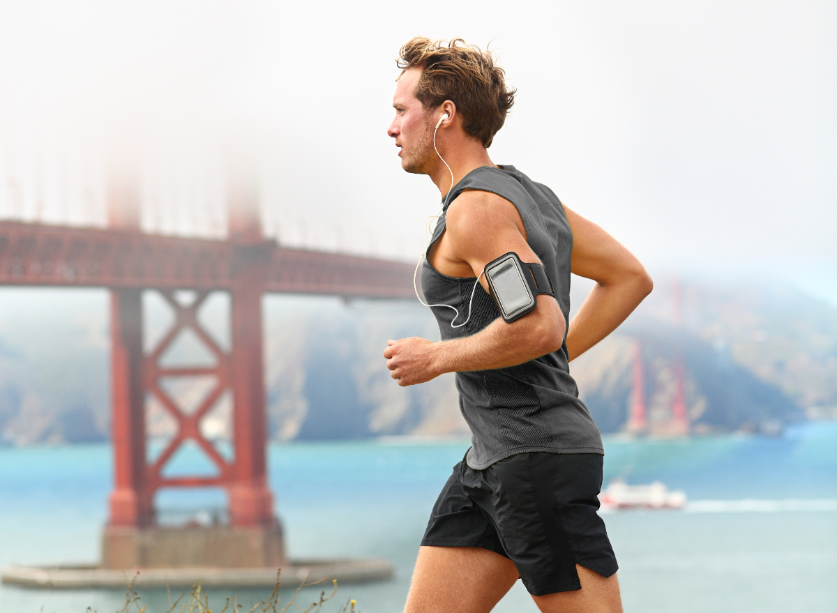 male runner runs on foggy day