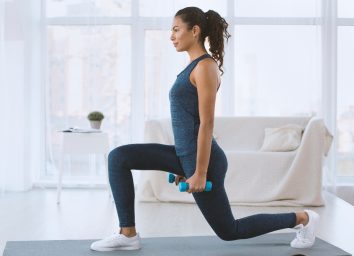 walking lunges with dumbbells to sculpt glutes