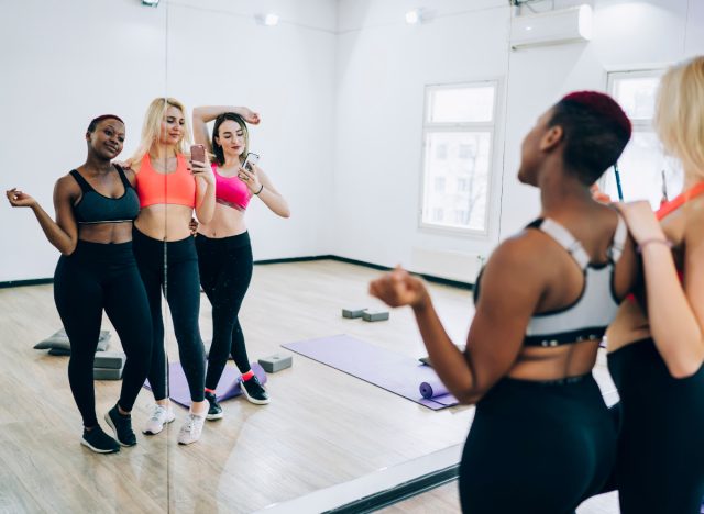 women take workout selfie in mirror