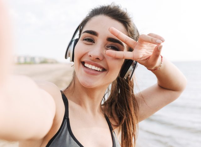 woman snaps workout selfie on beach