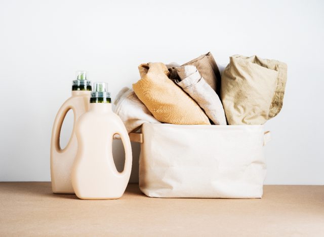 laundry detergents next to fresh laundry in basket