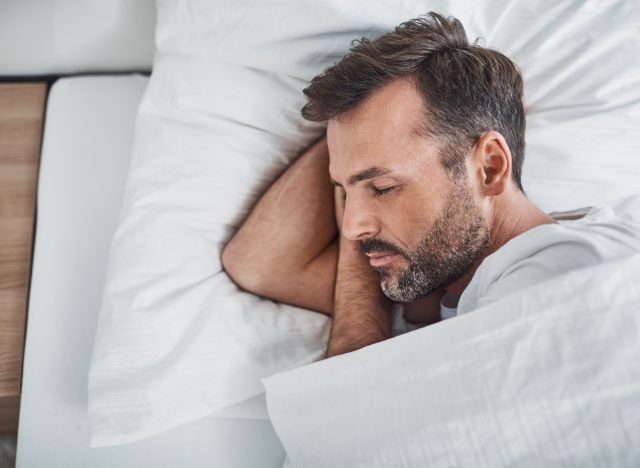 man sleeps peacefully after trying the best sleep hacks