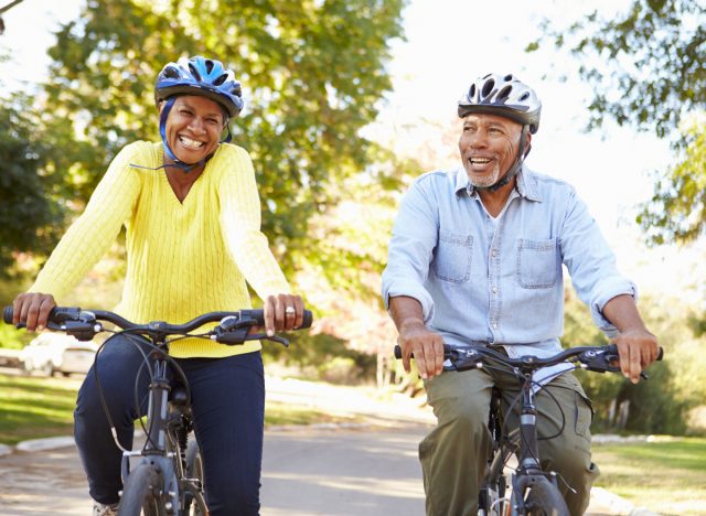 happy senior couple bike riding