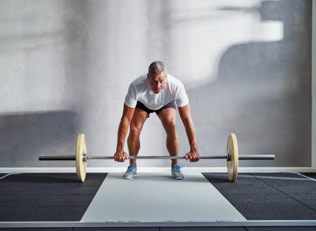 man works out in gym with weights