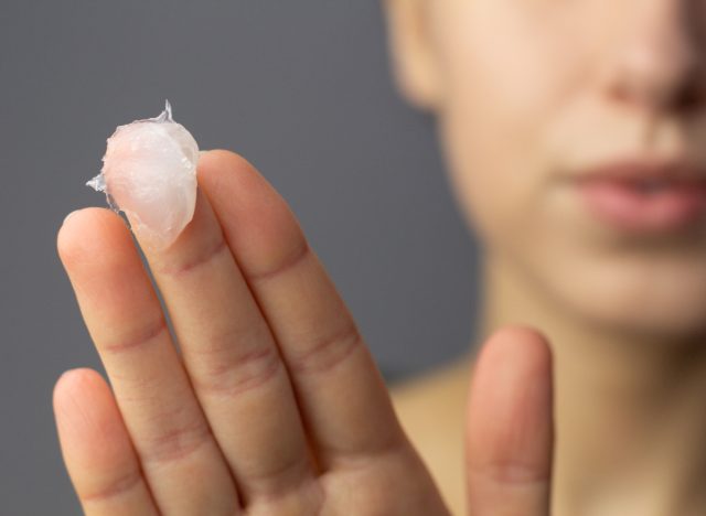woman with vaseline on her finger for slugging skincare