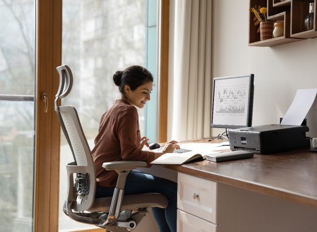 woman sitting in supportive desk chair in home office