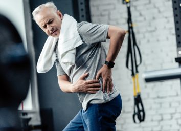 senior man dealing with chronic pain at the gym