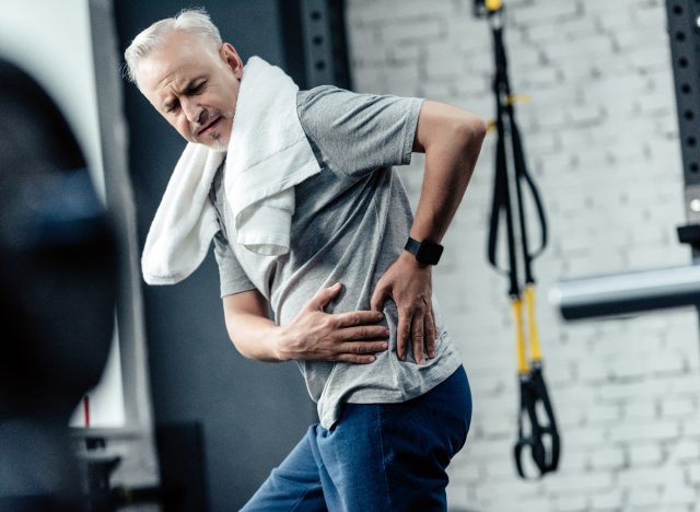 senior man dealing with chronic pain at the gym