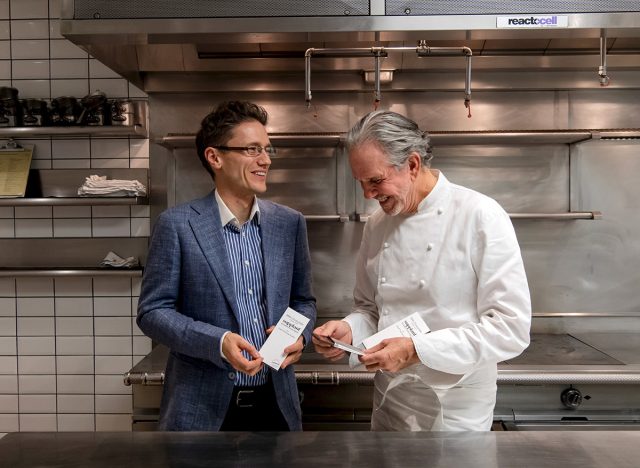 doctor thomas simmons and chef thomas keller in the kitchen holding supplant company chocolate bars