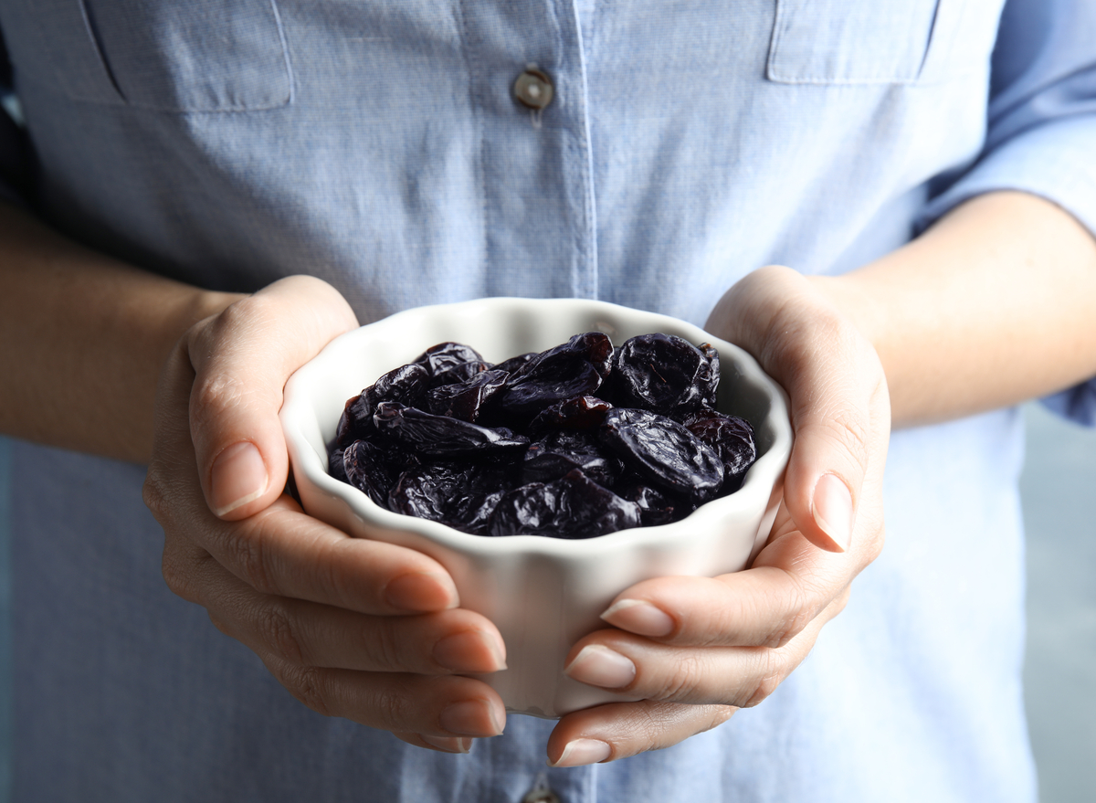holding bowl of prunes