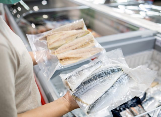 holding frozen fish in grocery store