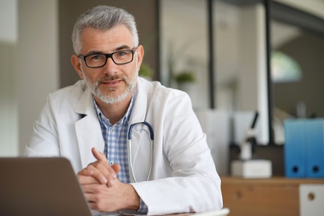 Portrait of confident doctor in private clinic