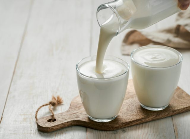 pouring probiotic drink into glass