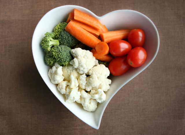 raw vegetables in a heart shaped bowl