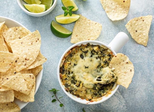 spinach dip with chips and lime slices