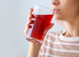 woman drinking pomegranate juice