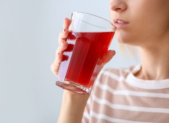 woman drinking pomegranate juice