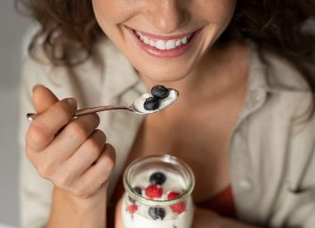 woman eating yogurt and berries