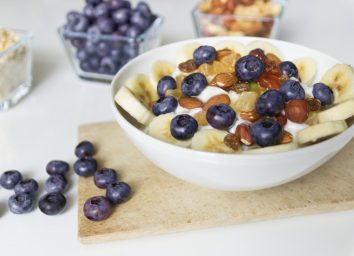 yogurt with blueberries, bananas, nuts, and honey