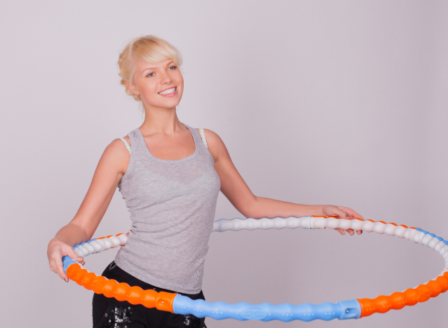 woman posing with weighted hula hoop