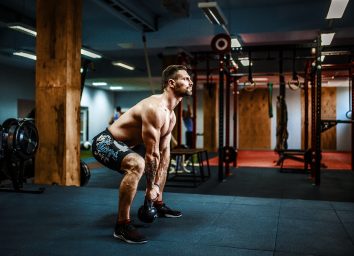 man performing intense kettlebell swings