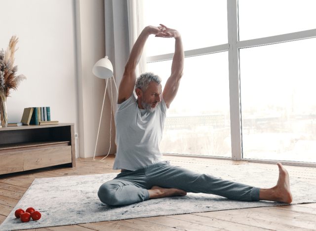 A man stretching with yoga movements to improve flexibility